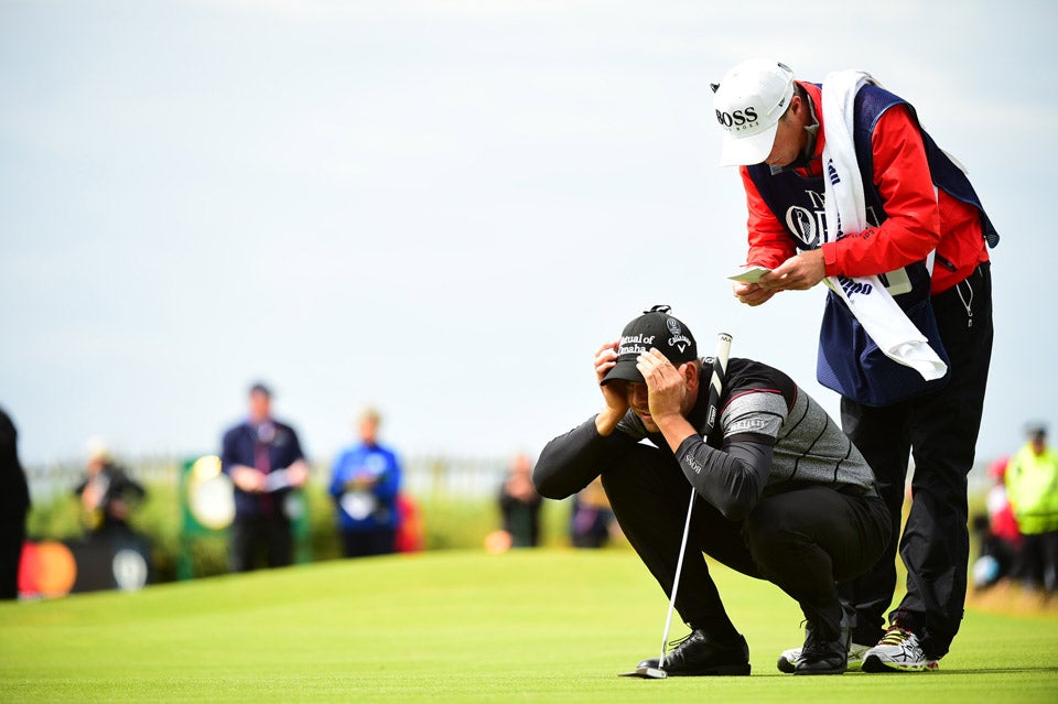 Henrik Stenson crouches to read a putt during the final round of the British Open.