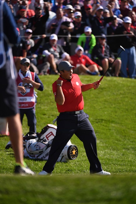 Patrick Reed celebrates the putt that won his first match on Friday.