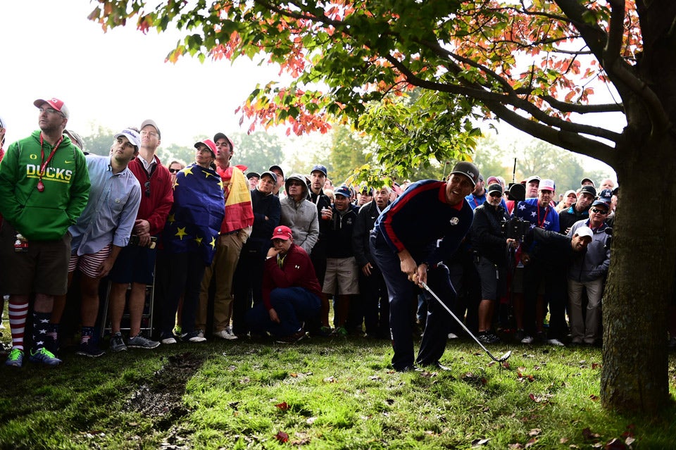 Phil Mickelson hits out of trouble during the first day of action.