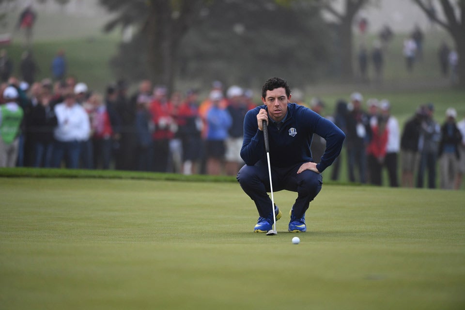Rory McIlroy lines up a putt.