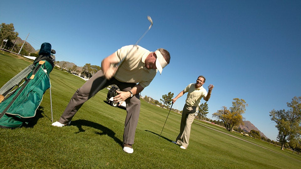 Golfer teeing up at the driving range