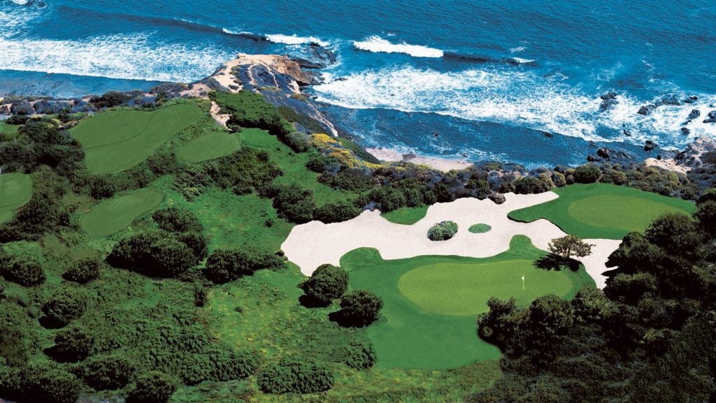 An aerial view of the majestic 123-yard par-3 13th hole at Pelican Hill's Ocean South Course.