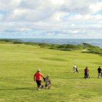 A foursome plays at Kahuku Golf Couse on the North Shore of Oahu in Hawaii.