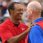 Tiger Woods shares a moment with caddie Joe LaCava after winning the 2018 Tour Championship.