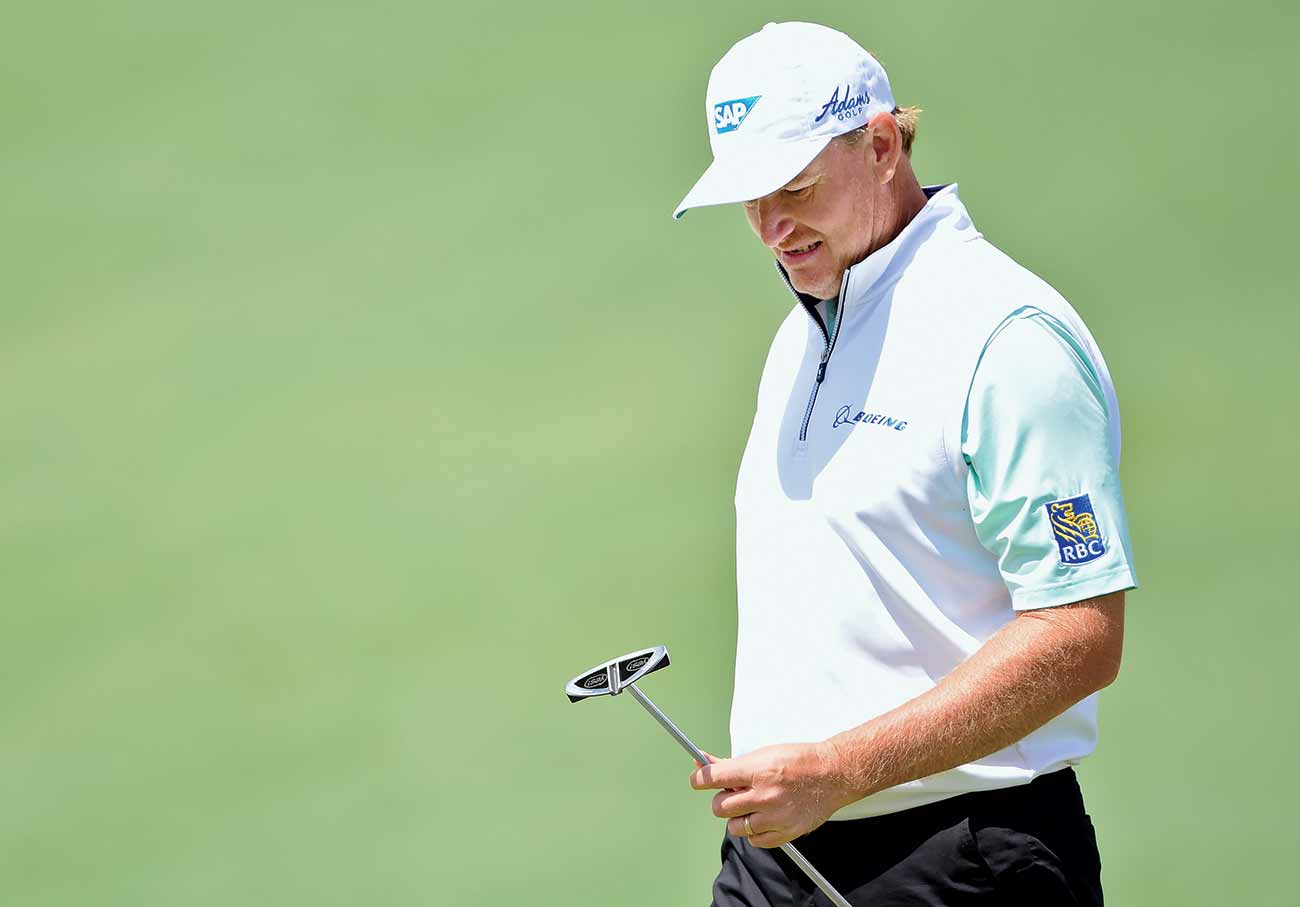 Ernie Els looks at putter at Masters.