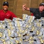 Tiger Woods and Phil Mickelson stand over huge stacks of money to promote their match.