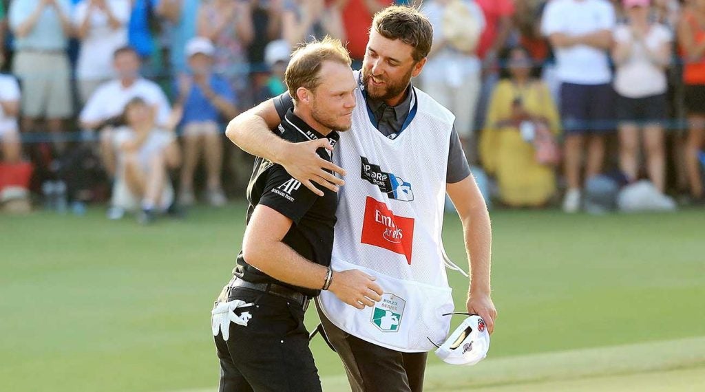 Danny Willett walks off the green with his caddie.