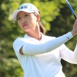 Doris Chen watches a tee shot.