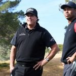 Phil Mickelson and Tiger Woods look on during The Match on Friday at Shadow Creek.