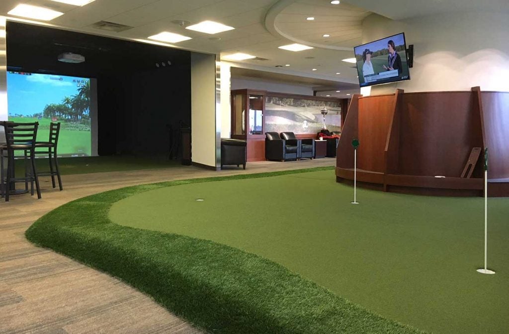 The putting green and a simulator at PGA MSP Airport.