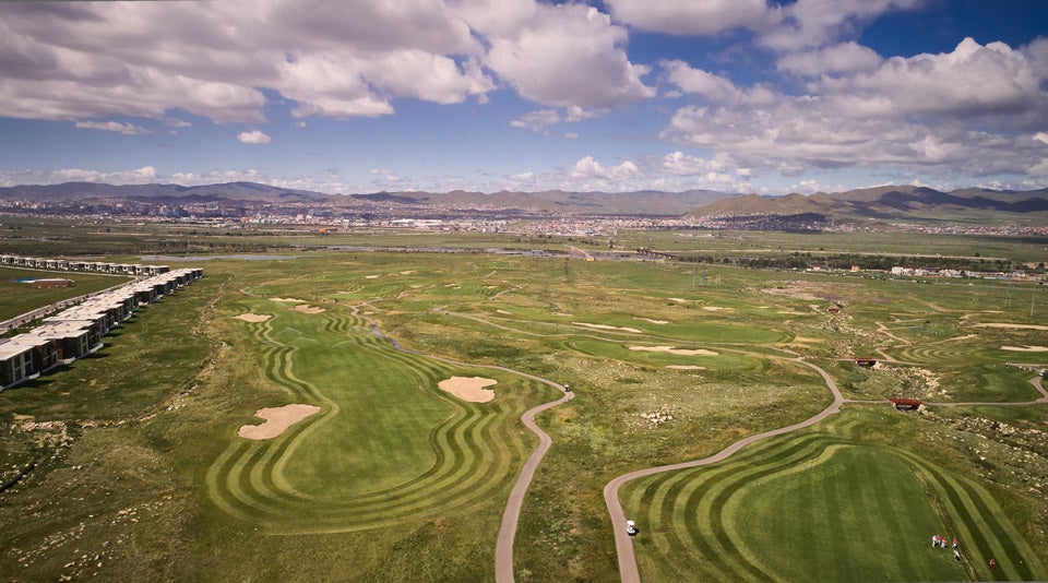 An aerial view of Mt. Bogd golf course, with Ulaanbaatar visible in background.