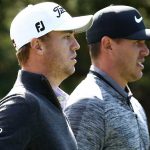 Justin Thomas and Brooks Koepka walk down the fairway.