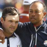 Patrick Reed and Tiger Woods walk off the green at the 2018 Ryder Cup.