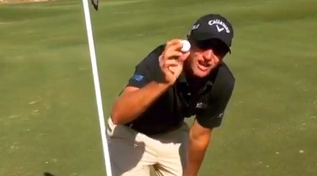 Nicolas Colsaerts shows off his golf ball after making a hole-in-one on a par-4.