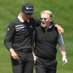 Haotong Li and European Tour Chief Executive Keith Pelley walk down the fairway during the 2018 BMW PGA Championship.