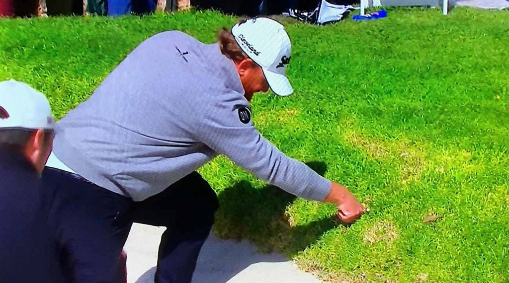 J.B. Holmes looks for his ball in the rough at Riviera Country Club.