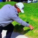 J.B. Holmes looks for his ball in the rough at Riviera Country Club.