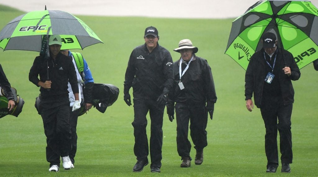 Phil Mickelson walks off the 10th hole after play was suspended on Thursday morning at the Genesis Open.