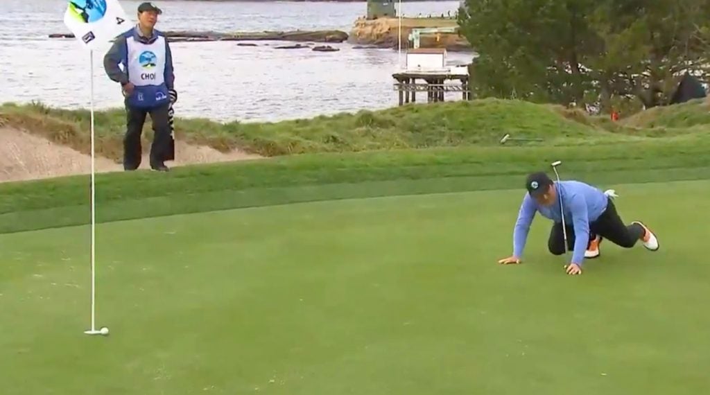 Hosung Choi crawls after his putt during the third round of the 2019 AT&T Pebble Beach Pro-Am