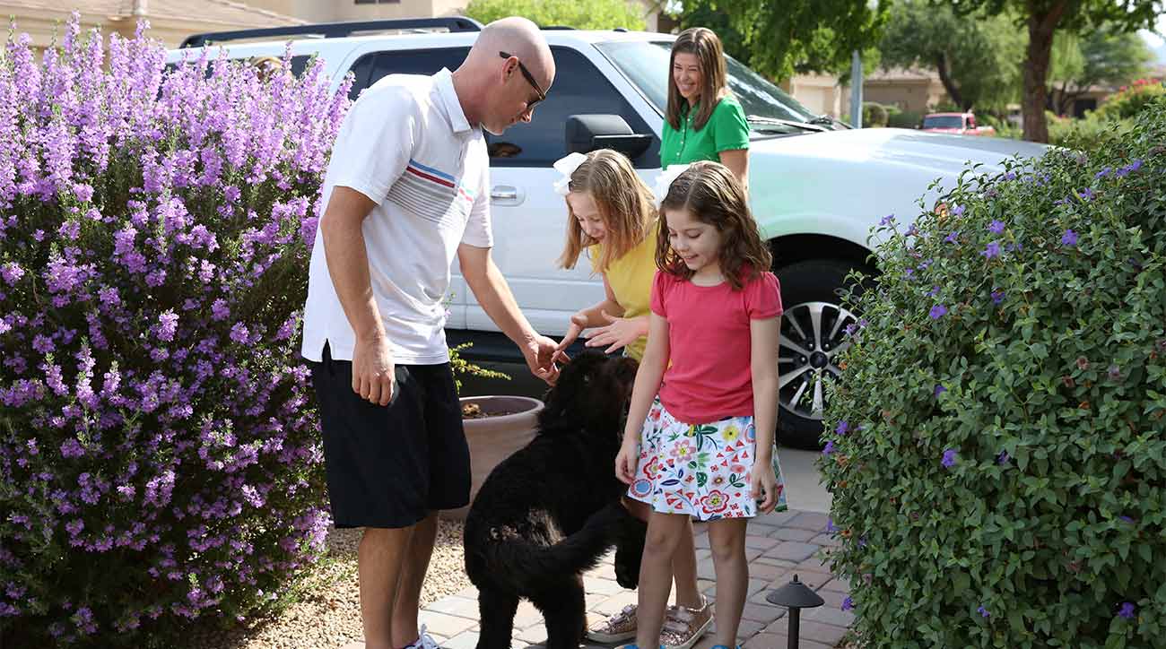 The Kahn family (Amelia, left; Makenzie, right) with Pongo, who is trained as a service dog to help the girls.