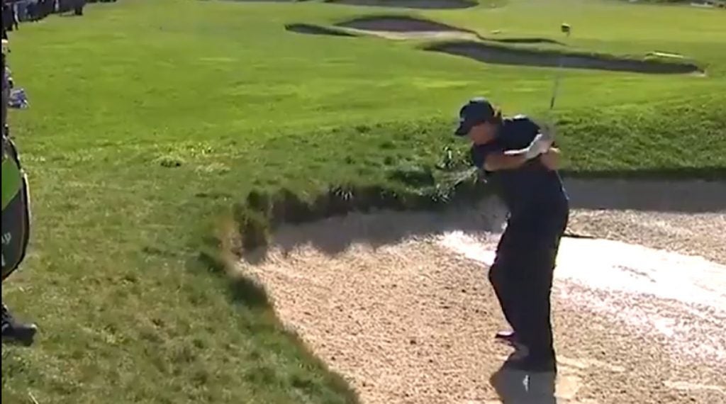 Phil Mickelson hits his wedge shot on the 4th hole at Pebble Beach on Saturday