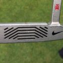 Tony Romo is using one of Tiger Woods' old Nike Method 001 putters.