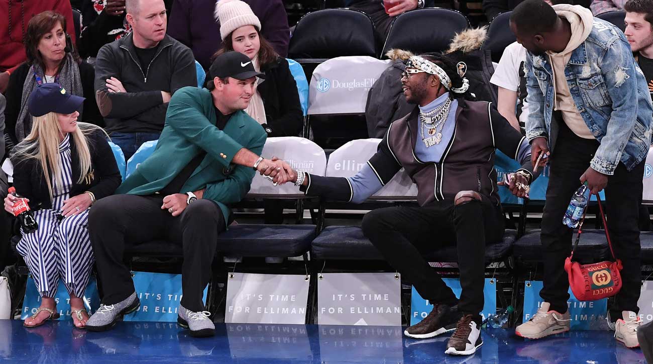 Patrick Reed and his wife, Justine, greet rapper 2 Chainz during a Knicks game last Spring.