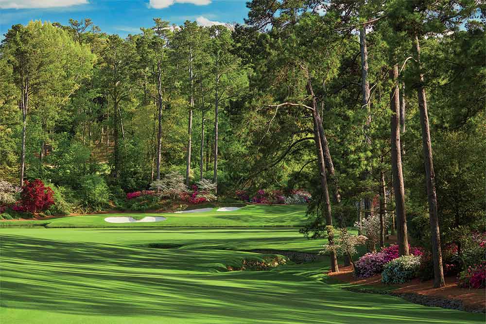 A view of the 12th green and 13th tee box (tucked back to the right) from the 13th fairway of Augusta National.