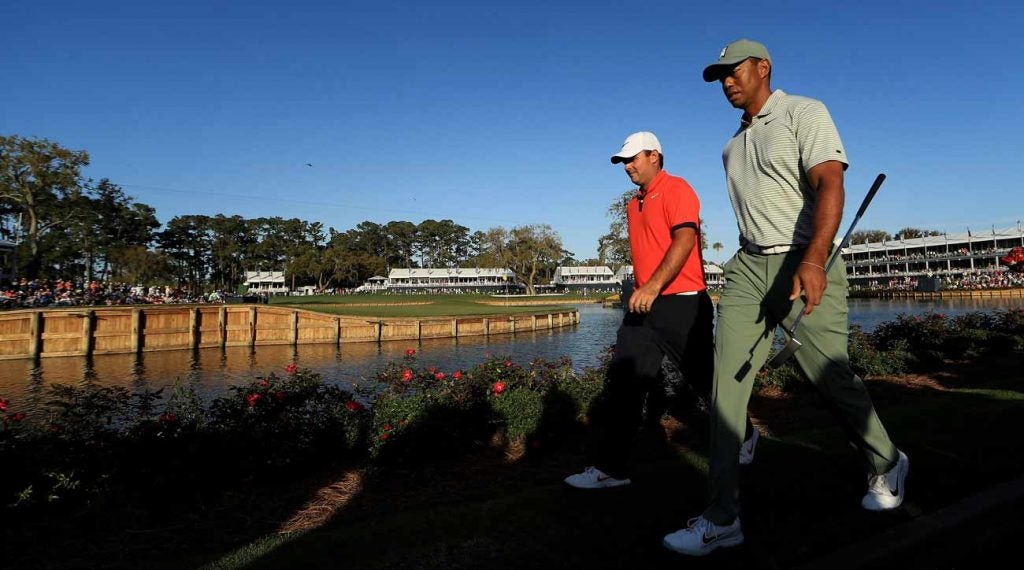 Tiger Woods and Patrick Reed walk down No. 17 together on Thursday.