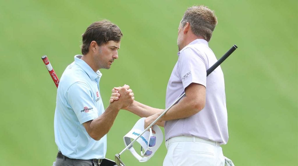 Kevin Kisner and Ian Poulter shake hands after their match on Wednesday at the WGC-Dell Technologies Match Play.