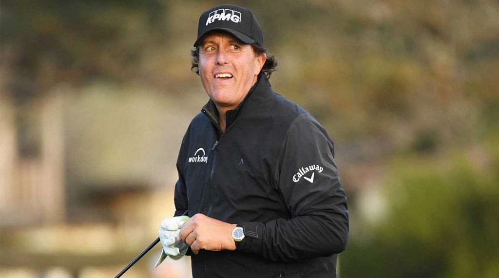 Phil Mickelson walks off the green.