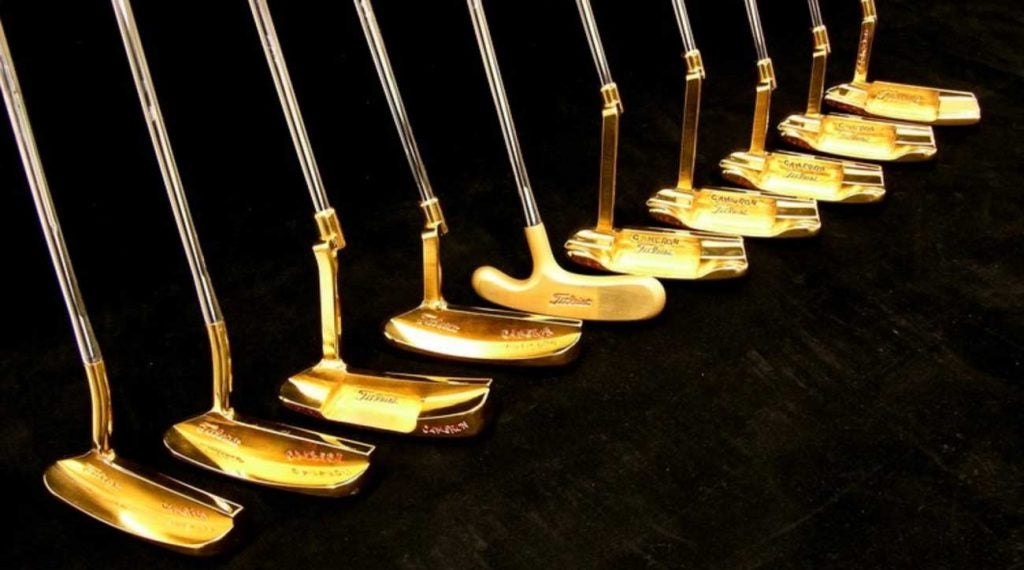 A trio of Tiger Woods winning putters are located within.