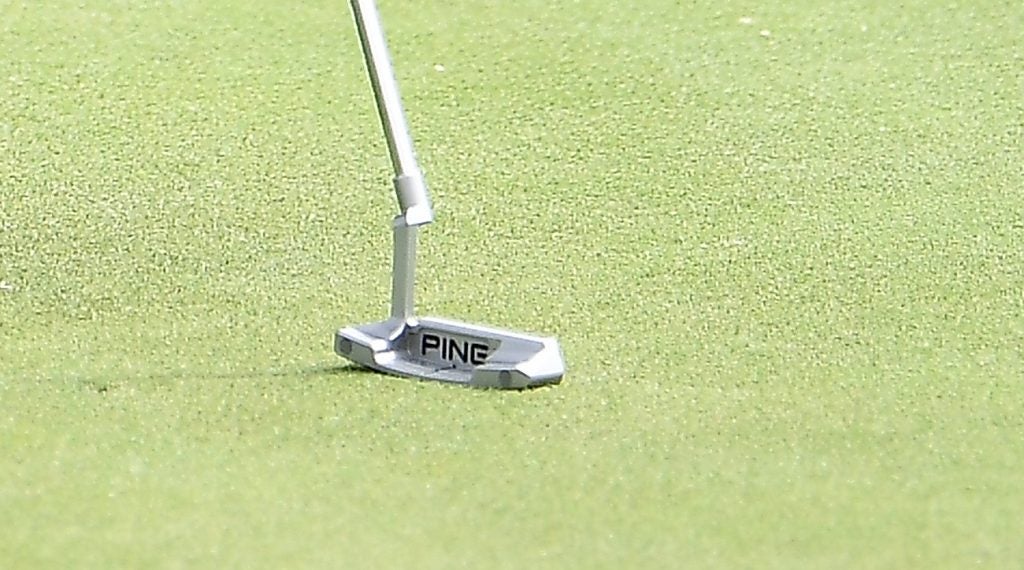 Weight plugs are visible in the bumpers of Corey Conners' Ping PLD Anser 2 putter. 