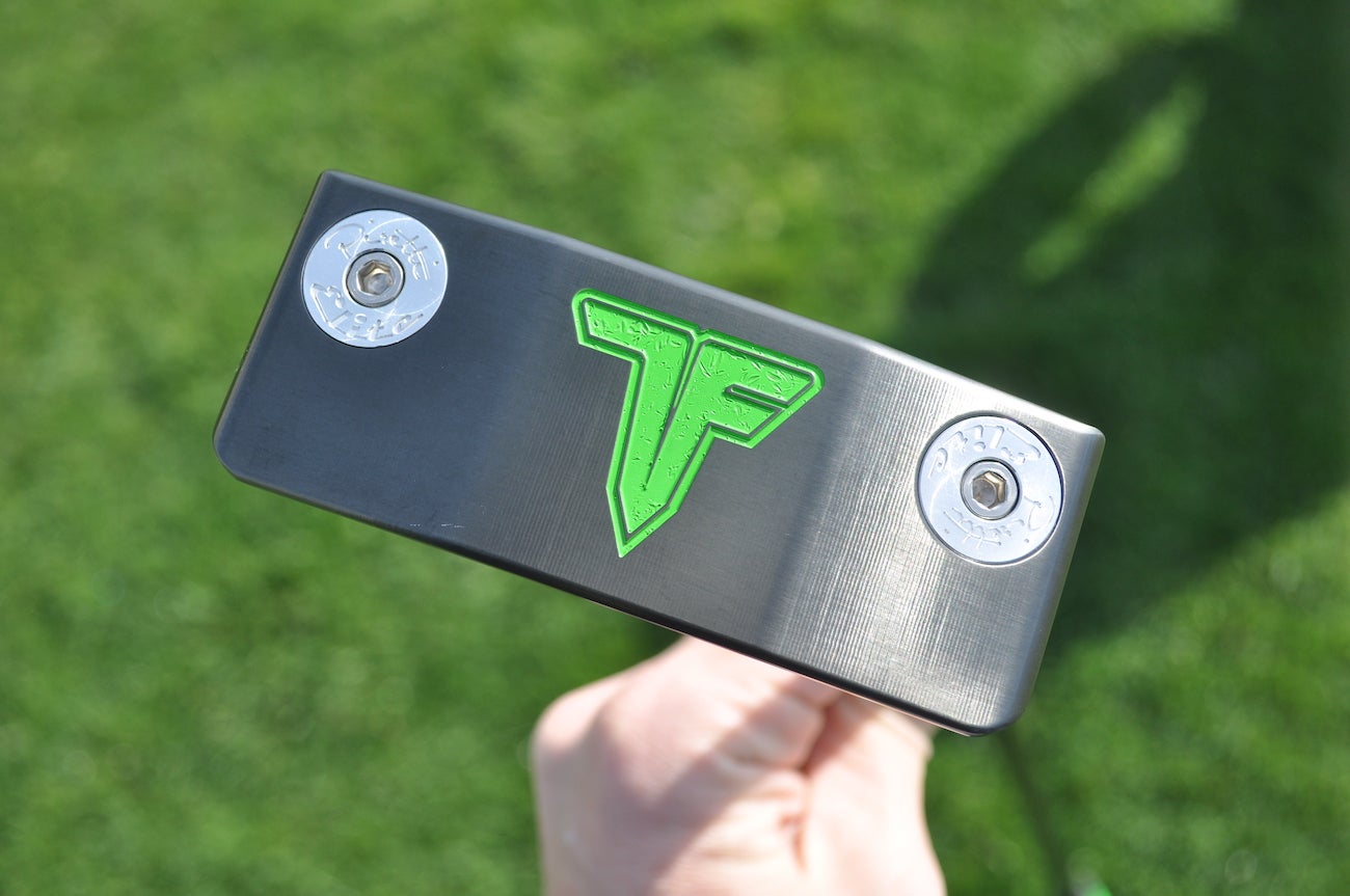 A custom Piretti putter made for Tony Finau with his personal logo etched into the sole and heel-toe weights. 