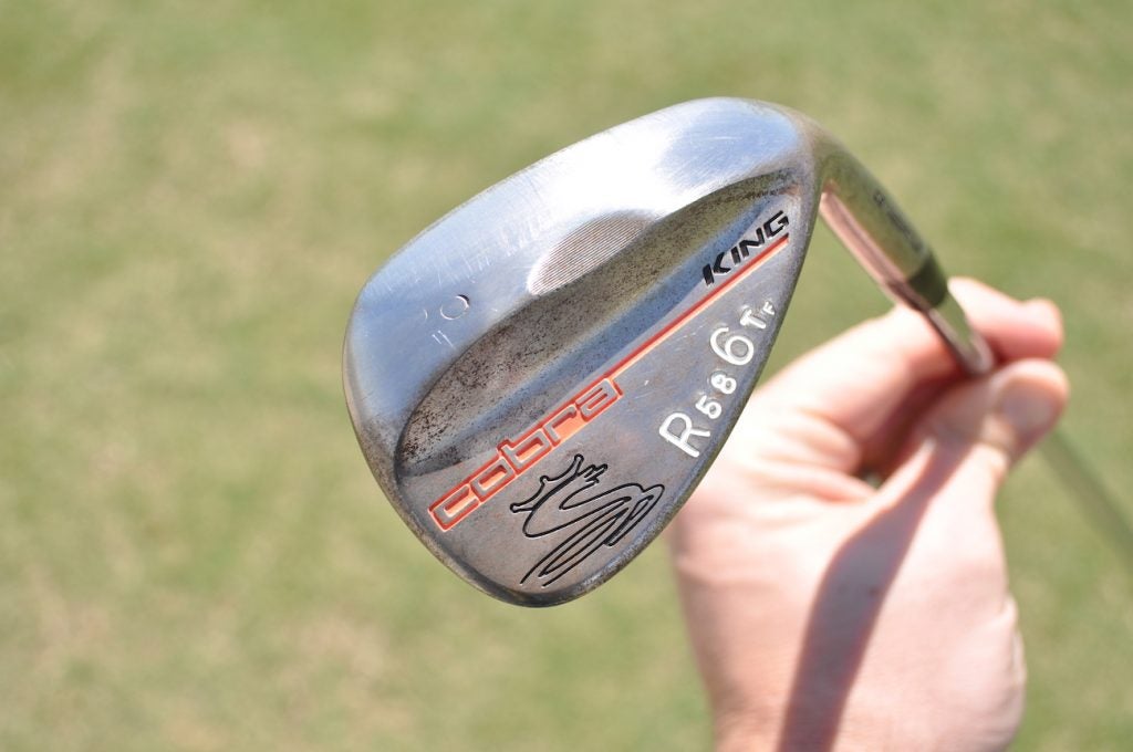 The 60-degree stamp on Rickie Fowler's lob wedge is nearly gone due to heavy toe grinding. 