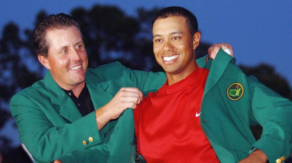 Phil Mickelson puts the Masters green jacket on Tiger Woods.