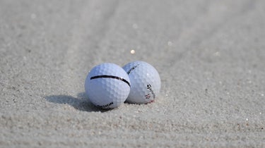 Two golf balls in bunker