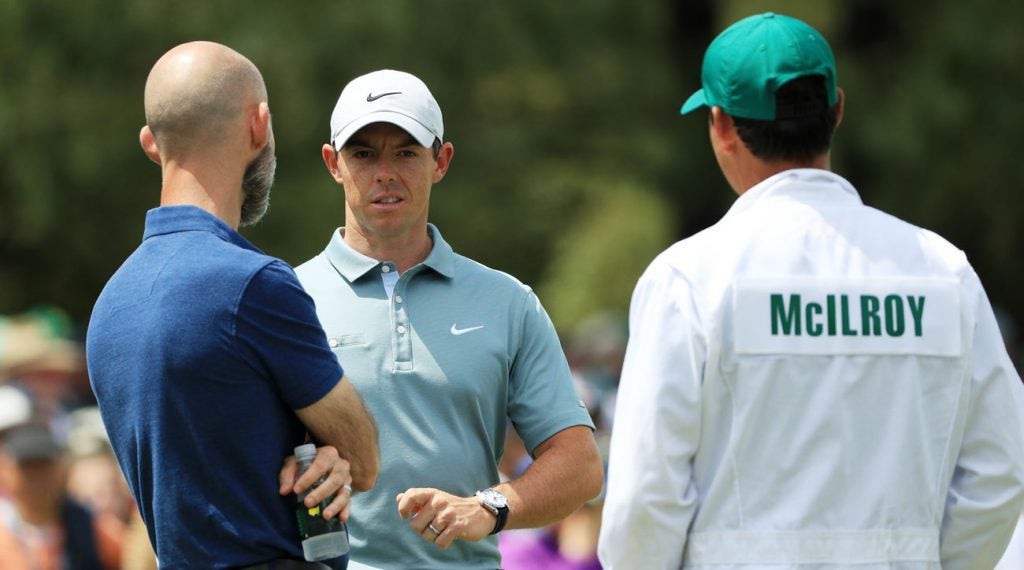 Rory McIlroy (center) talks with Dr. Clayton Skaggs and his caddie Harry Diamond on the putting green Tuesday afternoon.