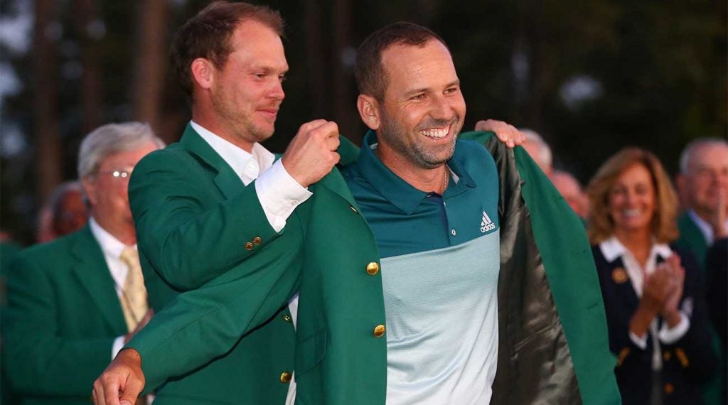 Danny Willett puts the green jacket on Sergio Garcia after Garcia won the Masters in 2017. This year's winner will receive a record payout.