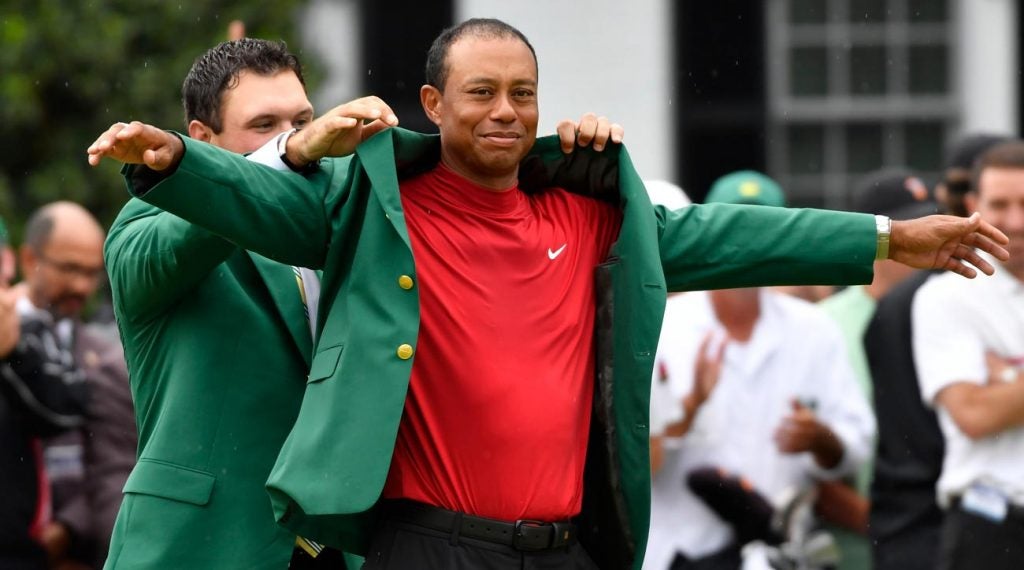 Patrick Reed helps Tiger Woods into his green jacket Sunday at the 2019 Masters.