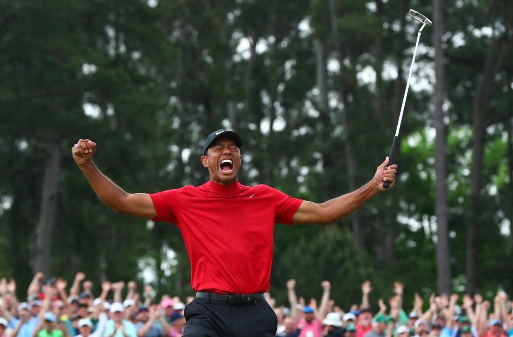 Tiger throws his arms into the air moments after sinking the winning putt at the 2019 Masters.