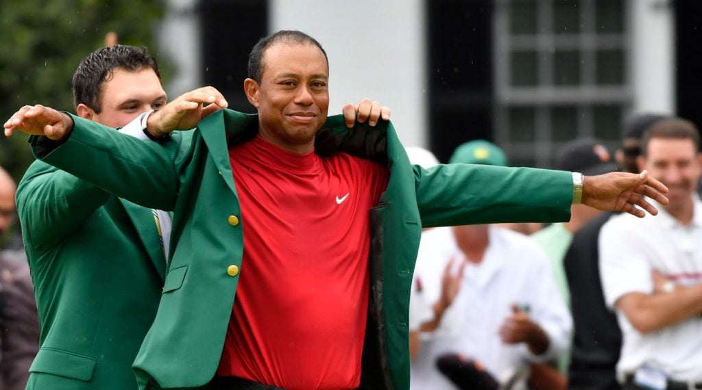 Tiger Woods slips on the green jacket at the 2019 Masters.