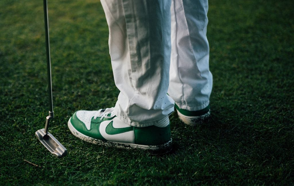 Paul Casey's caddie is celebrating the week with Masters-green Nikes.