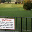 Bethpage Black's Warning sign dares golfers to play the Black Course.