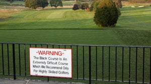 Bethpage Black's Warning sign dares golfers to play the Black Course.