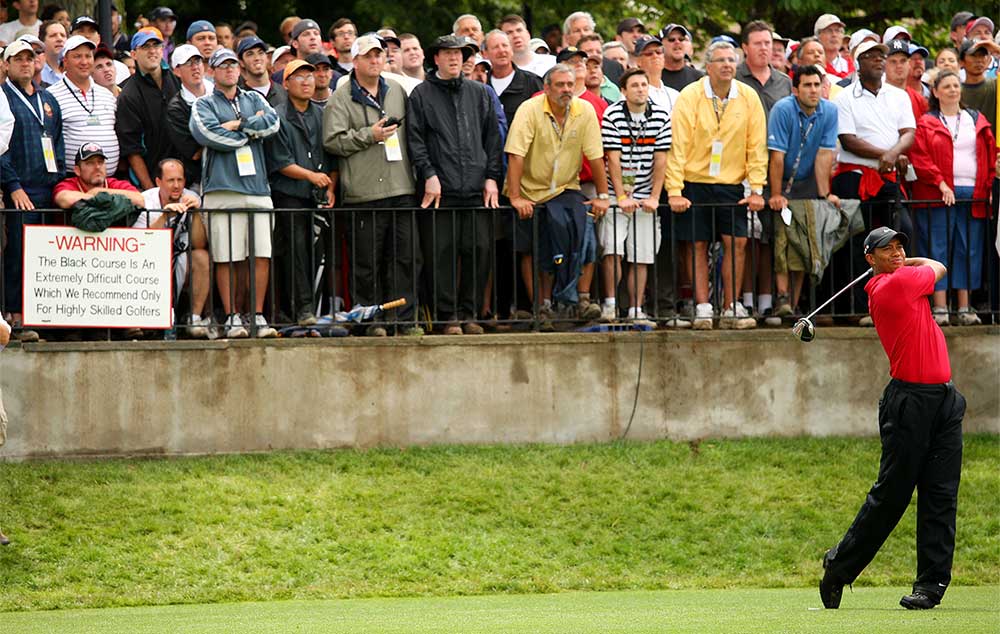 Tiger Woods tees off during the final round of the 2009 U.S. Open at Bethpage Black, with the sign just feet away from him.