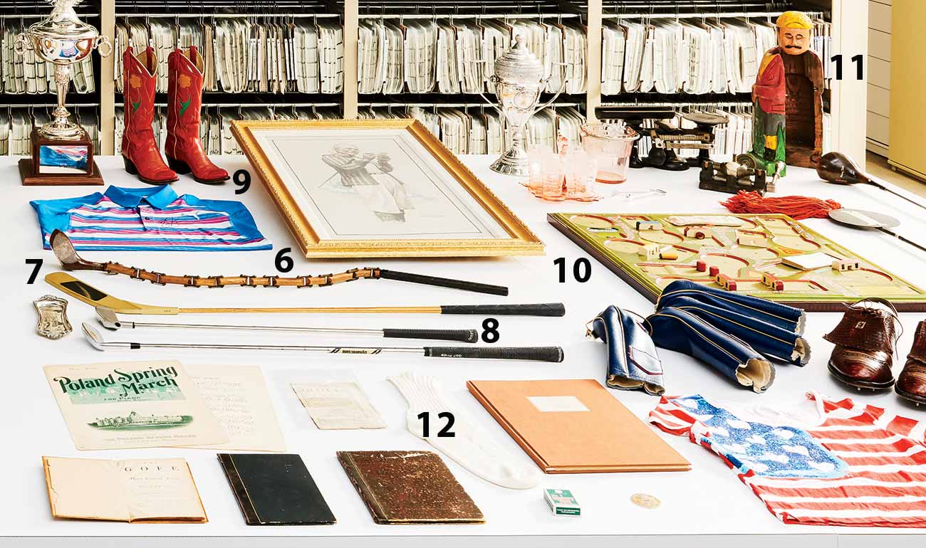 Above: 6. Sectional driver designed by trick-shot maestro Joe Kirkwood; 7. Modified putter from  Happy Gilmore; 8. Club used on Mt. Everest by Robert C. Vaughn to break the record for a golf shot hit from the highest elevation; 9. LPGA Tour winner Barbara Romack’s Ralph Lauren cowboy boots; 10. Gibbs Golf board game (ca. 1930); 11. Prohibition-era figurine used to hide liquor bottles (ca. 1920); 12. Sock used by Alan Shepard in 1971 to hold the golf club head used for his Apollo 14 moon shot.
