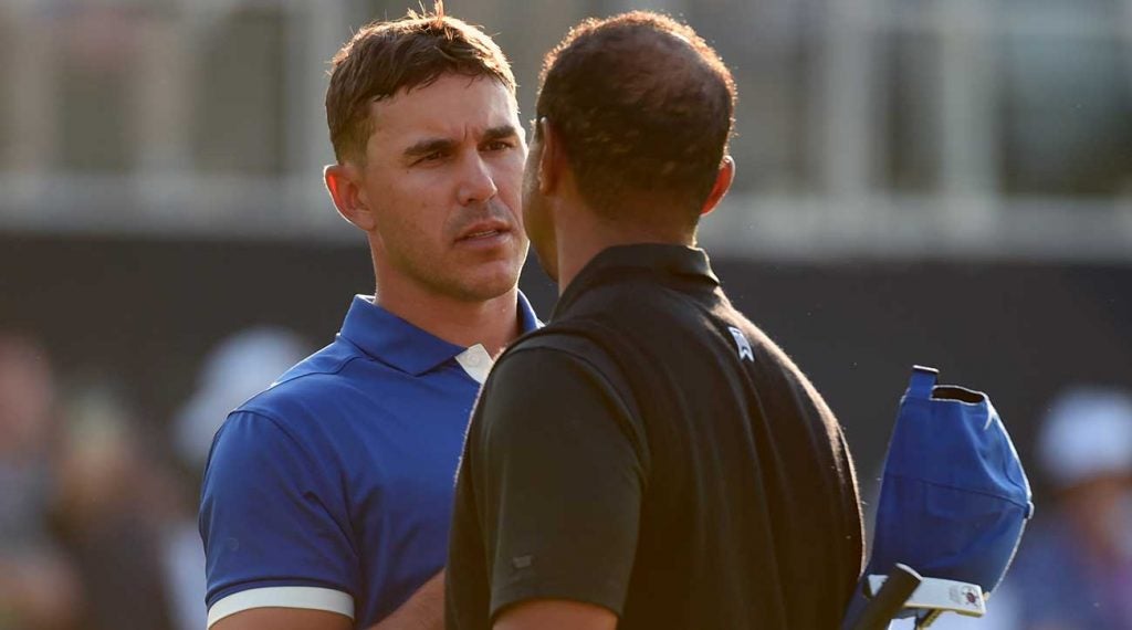 Brooks Koepka and Tiger Woods shake hands after their round together on Friday at the PGA Championship.
