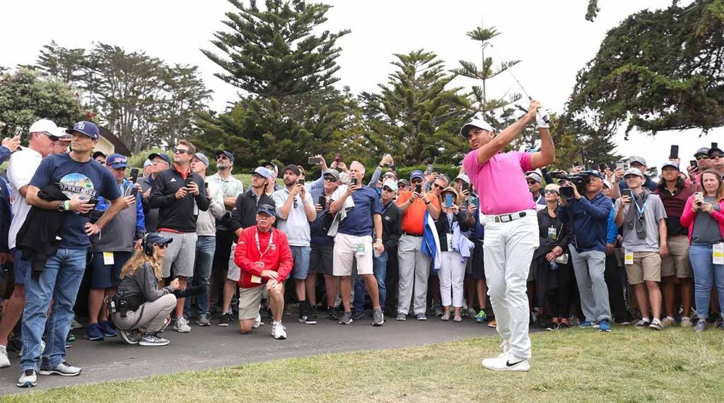 Jason Day hits his second shot on the par-5 18th on Thursday at Pebble Beach.