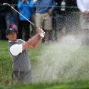 Tiger Woods blasts out of a bunker during the first round of the 2019 U.S. Open.
